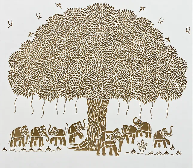 Paper-cut tree with elephants beneath its branches.