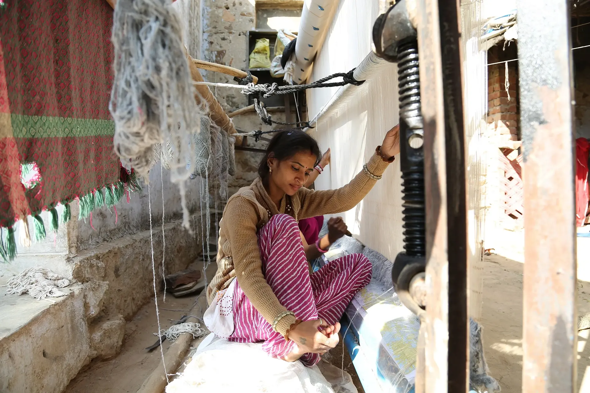 Worker in a labour-intensive production setting in one of Tri-Impact's field geographies.
